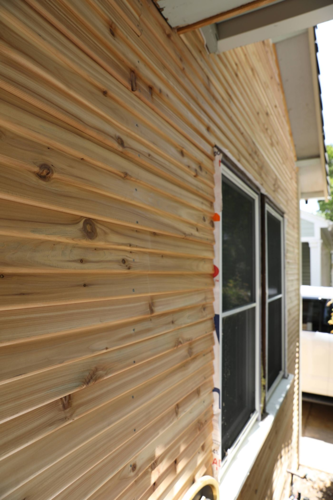 Close up of fresh tear drop siding featuring a window
