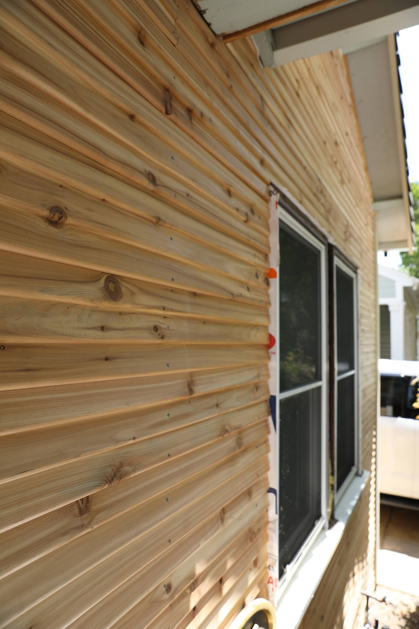 Close up of fresh tear drop siding featuring a window